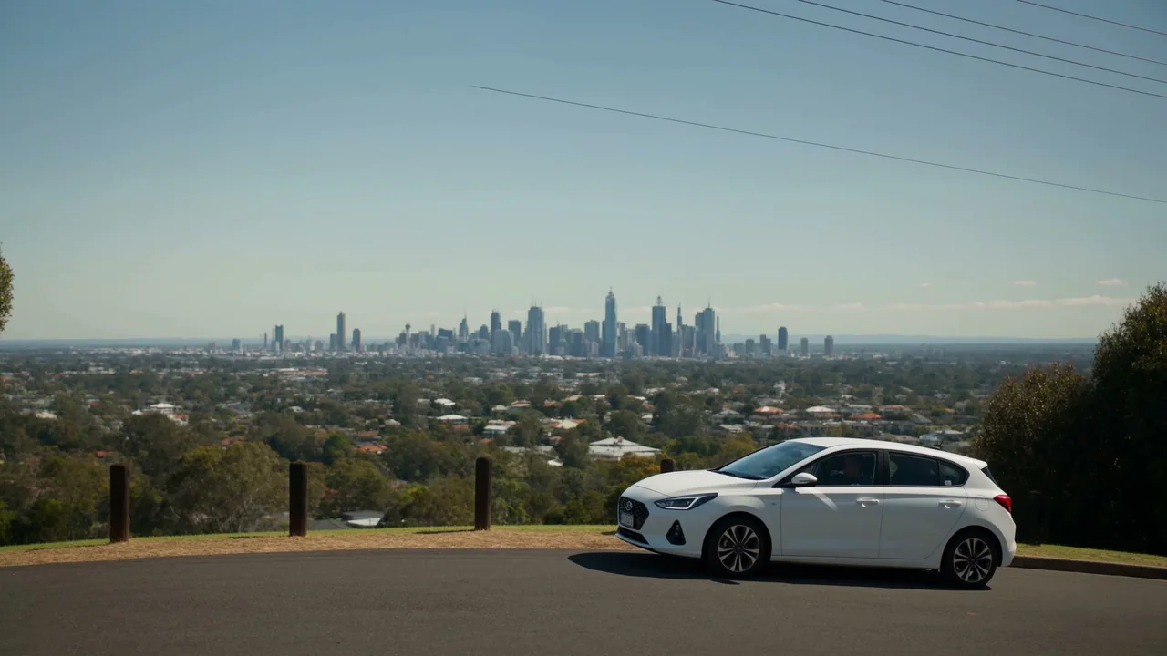 The training car parked alone at a ridge lookout over the Brisbane skyline